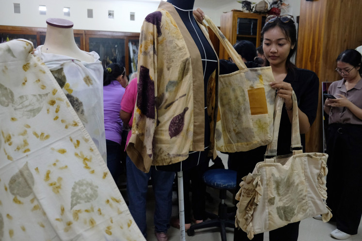 A participant arranges bags made during a small business training program on May 14, 2024, in Denpasar, Bali.