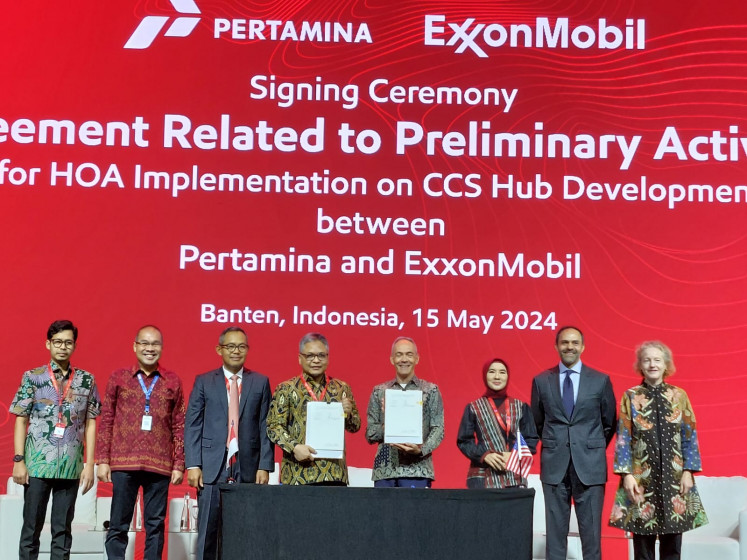 Jodi Mahardi, undersecretary for maritime sovereignty and energy coordination at the Office of the Coordinating Maritime Affairs Minister (third left) and Pertamina president director Nicke Widyawati (third right) are pictured at the signing ceremony for a heads of agreement on the development of a carbon capture and storage (CCS) hub at the Indonesia Petroleum Association's annual conference in Jakarta on Wednesday.