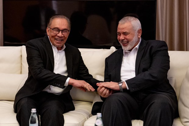 Malaysian Prime Minister Anwar Ibrahim (left) is seen with Ismail Haniyeh, leader of the Palestinian group Hamas, in a photo posted by the PM on his Facebook account, on May 14, 2024, to which the accompanying post said they met in Qatar.