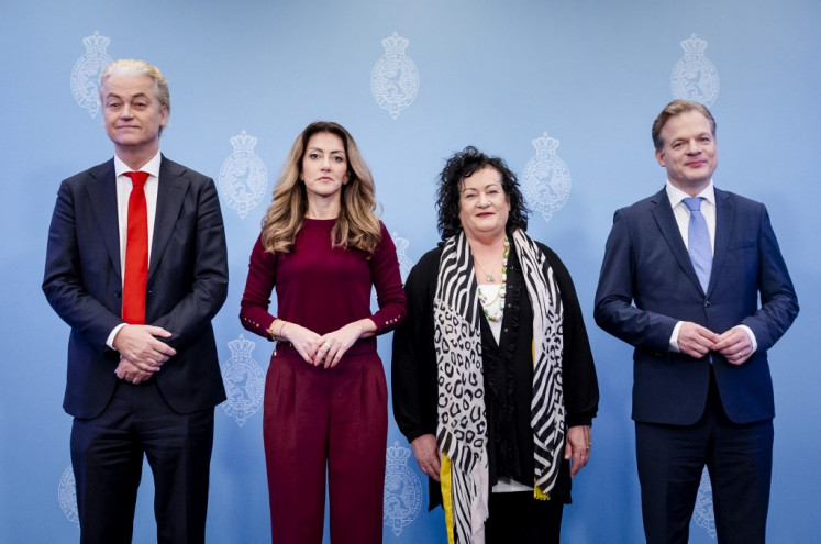 Netherlands' party leaders (from left) Geert Wilders (PVV), Dilan Yesilgoz (VVD), Caroline van der Plas (BBB) and Pieter Omtzigt (NSC) pose during a press presentation of the main lines of the 26-page coalition cabinet agreement they reached earlier on May 16, 2024 in The Hague after six months of gruelling talks between four parties following the stunning PVV election victory. 