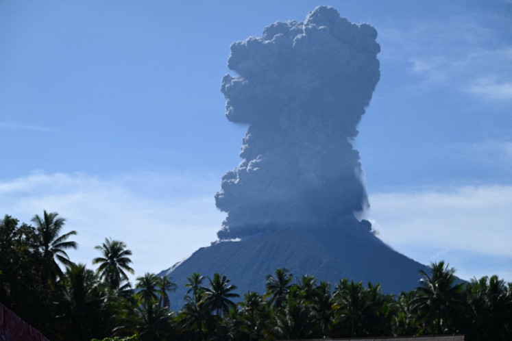 This handout photo taken and released by the Center for Volcanology and Geological Hazard Mitigation (PVMBG) on May 13, 2024 shows Mount Ibu spewing thick smoke in North Maluku Province.