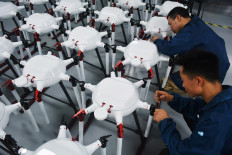 Employees work on the production line for drones at a workshop in Anqing, Anhui province, China, on May 16, 2024.