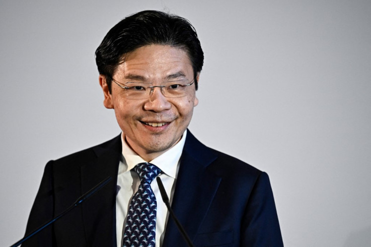 Singapore's Prime Minister Lawrence Wong delivers a speech during the Paris office opening reception of Singapore state investor Temasek in Paris on April 10, 2024. 
