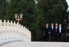 In this pool photograph distributed by the Russian state agency Sputnik, Russia's President Vladimir Putin and China's President Xi Jinping take a walk in Beijing on May 16, 2024. 