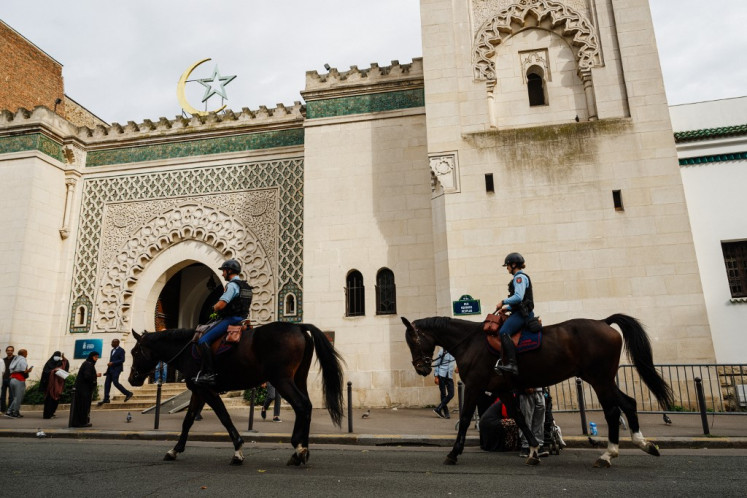 French mounted Police patrol in front of the Grand Mosque of Paris during Muslim's Friday noon prayer in Paris on October 13, 2023 as rector Chems-Eddine Hafiz is expected to deliver a sermon on the situation in the Middle East. 