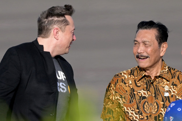 Tech billionaire Elon Musk (left) walks with Coordinating Maritime Affairs and Investment Minister Luhut Pandjaitan during his arrival at I Gusti Ngurah Rai International Airport in Denpasar, Bali on May 19, 2024. Musk landed in Bali to inaugurate satellite unit Starlink, which is expected to provide internet services to the archipelago's remote areas.