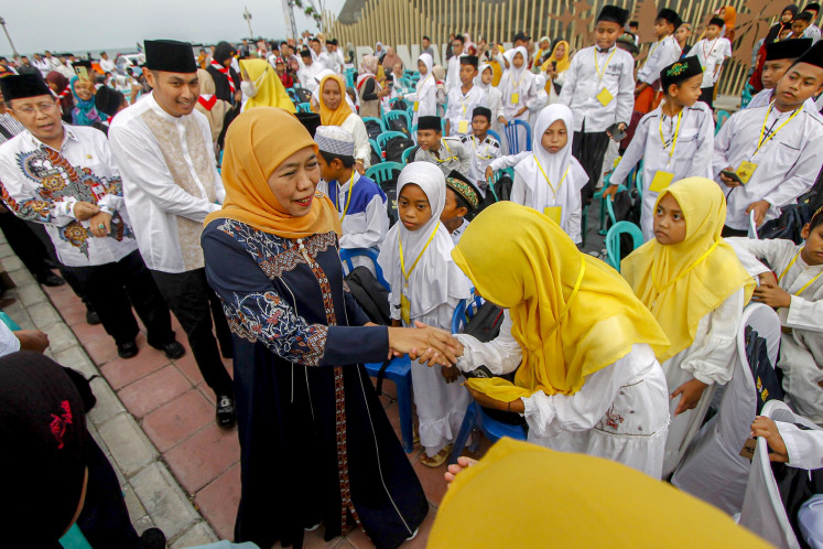 Khofifah Indar Parawansa (center), the leader of Islamic group Nahdlatul Ulama's (NU) women's wing Muslimat NU, greets orphans during a social aid disbursement event in Tuban, East Java, on April 5, 2024.