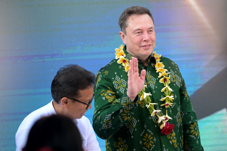 Tech billionaire Elon Musk (right) gestures upon his arrival in Bali on May 19, 2024, to inaugurate the Starlink satellite internet service at a community health center (Puskesmas) in Denpasar.