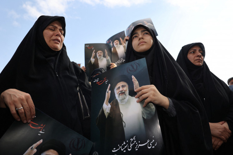 People gather to mourn the death of Iran's President Ebrahim Raisi, in Tehran on May 20, 2024. 