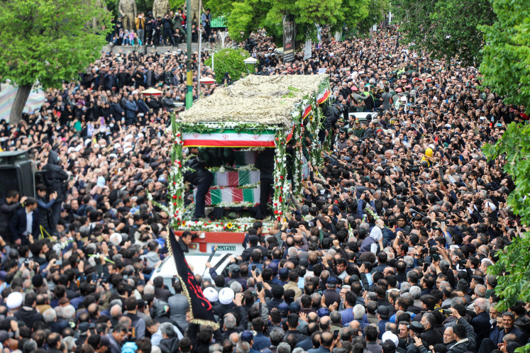 People participate in a funeral procession on May 21, 2024, alongside a
truck carrying the coffins of Iranian president Ebrahim Raisi and his aides in
Tabriz, East Azerbaijan province, Iran. 