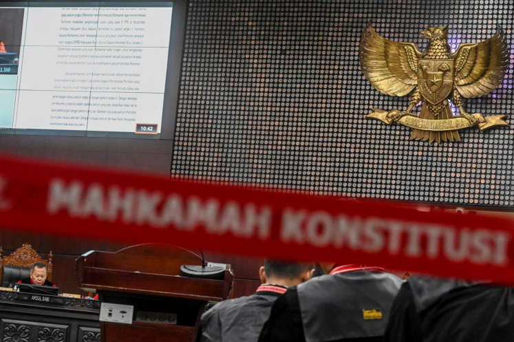 Constitutional Court Justice Arsul Sani (left) reads a ruling against a legislative election dispute petition at the court building in Jakarta on May 21, 2024.