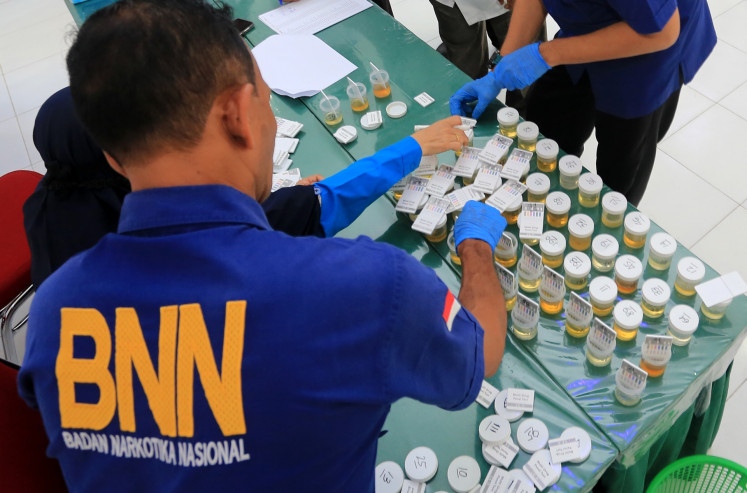 Officials of the National Narcotics Agency's (BNN) regional office in Aceh check on urine samples gathered from civil servants of the West Aceh regency office of the Religious Affairs Ministry on May 14, 2024.