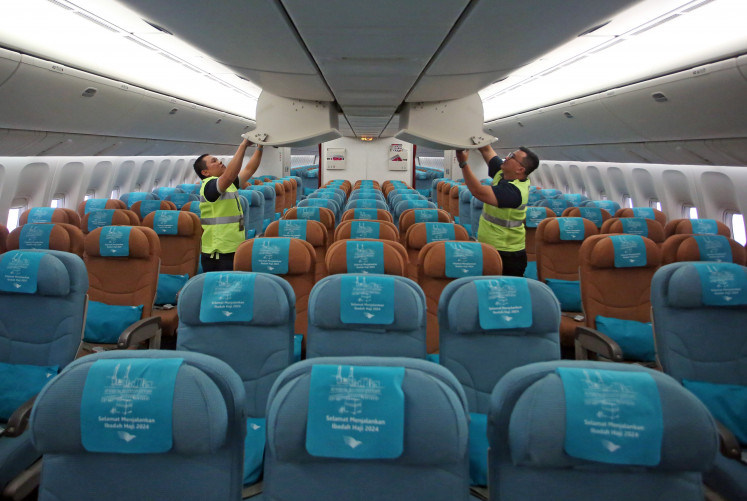 Maintenance workers clean a Garuda Indonesia aircraft on May 8, 2024, at a hangar at Soekarno-Hatta International Airport in Tangerang, Banten. 
