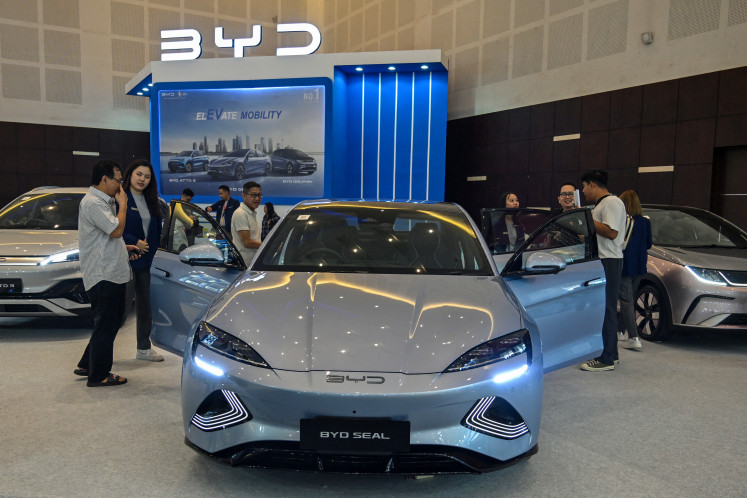 People visit the booth of Chinese automobile manufacturer BYD during the Indonesia
International Motor Show (IIMS) in Surabaya, East Java, on May 29, 2024. The government is
hoping to triple domestic electric car sales this year to 50,000 units, banking on newly rolled-
out incentives to boost the industry. Last year, 17,000 electric vehicles (EVs) were sold

wholesale nationwide, according to the Association of Indonesian Automotive Manufacturers
(Gaikindo).