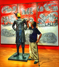Butet Kartaredjasa posed with the exhibition's titular installation “Melik Nggendong Lali“. According to the artist, stewardship of wealth and power often comes with forgetfulness. Photo by Sylviana Hamdani.