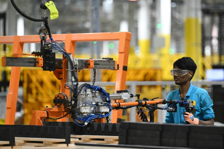 A worker operates a machine at the First Solar manufacturing facility in Sriperumbudur, Kanchipuram district, on Jan. 11, 2024.