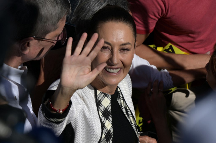 Mexico's presidential candidate for Morena party Claudia Sheinbaum waves on arrival at a polling station in San Andres Totoltepec, Tlalpan in Mexico City, during the general election on June 2, 2024. 