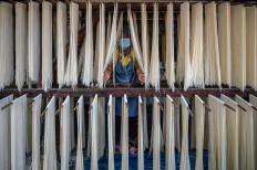 A worker produces noodles on Jan. 14, 2023, at a factory in Surabaya, East Java.