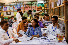 Election officials open an electronic voting machine (EVM) to count votes inside a counting center in New Delhi, India, June 4, 2024. 