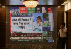 A man glances at results for India's general elections on a screen inside the Bombay Stock Exchange (BSE) in Mumbai, India, on June 4, 2024.