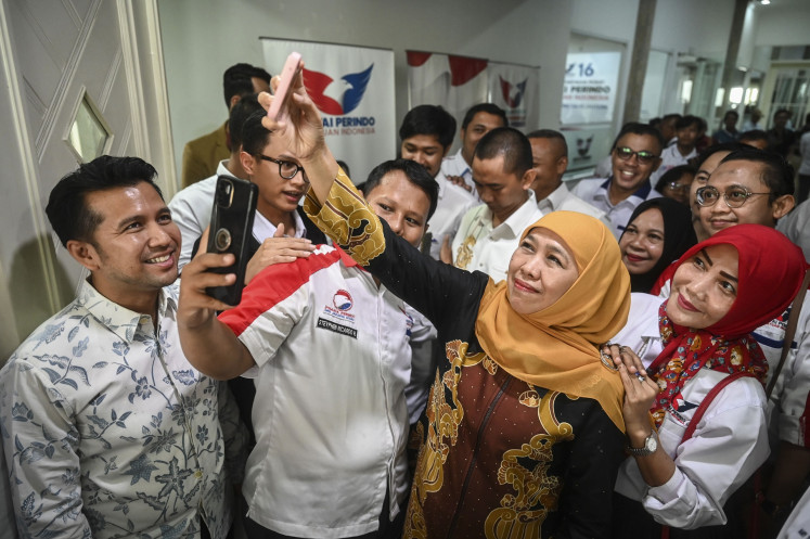 Former East Java governor Khofifah Indar Parawansa (second right), accompanied by former deputy governor Emil Dardak (left), takes a selfie with Perindo Party officials in the party's headquarters in Jakarta on May 22, 2024 after the party declared its early support for the pair in the upcoming East Java gubernatorial election on November.