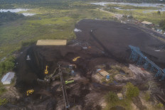 An aerial photo taken on May 6, 2024, shows a coal storage yard next to the Batanghari River in Muaro Jambi, Jambi, on May 6, 2024.