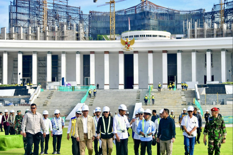 This handout picture taken and released on June 5, 2024 by the Presidential Palace shows President Joko Widodo (center) inspecting the venue that will be used for the celebration of Indonesia's 79th Independence Day in the future capital city of Nusantara in Penajam Paser Utara, East Kalimantan. 