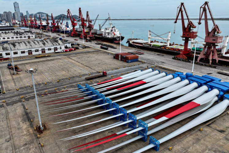 Wind turbine blades are stacked at a port in Lianyungang in eastern China's Jiangsu province on May 27, 2024.