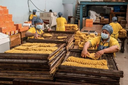 Oodles of noodles: Workers produce noodles at a factory in Surabaya, East Java, on Jan. 14, 2023.

