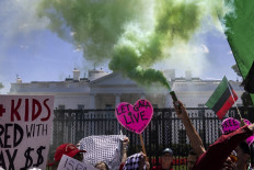 Pro-Palestinian activists set off smoke bombs on Pennsylvania Avenue in front of the White House during a demonstration protesting the war in Gaza on June 8, 2024 in Washington, US. As the Israeli invasion of Gaza following the October 7 terrorist attacks by Hamas militants on the Israeli people enters its 9th month the two sides have yet to reach a peace agreement. 