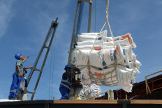 Workers unload sacks of imported Thai rice on June 10, 2024, at Malahayati Port in Aceh Besar, Aceh.