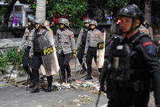 Police officers patrol the road in Kedung Cowek subdistrict, Surabaya, East Java, on May 31, 2024, following a clash between fans of soccer clubs Persib Bandung and Madura United that broke out after the match between the two clubs in Gelora Bangkalan Stadium, Bangkalan, East Java.