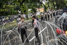 Police officers stand guard during a pro-Palestinian demonstration in front of the Egypt Embassy in Jakarta on May 19, 2024.