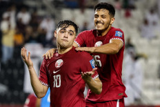 Qatar's forward #10 Ahmed Al-Rawi celebrates with his defender #16 Abdulla Al-Yazidi after the former scored his team's second goal during the 2026 FIFA World Cup AFC qualifiers football match between Qatar and India at the Jassim Bin Hamad Stadium in Doha on June 11, 2024. 