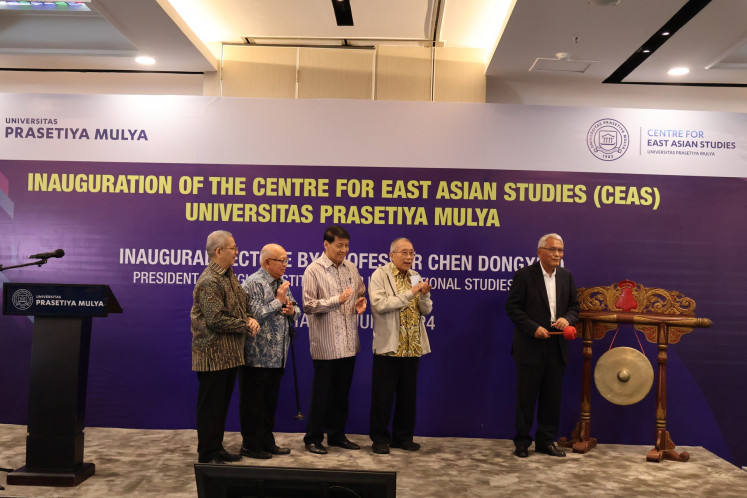 Prasetiya Mulya University rector Djisman Simanjuntak (right)—accompanied by Centre for Strategic and International Studies (CSIS) Board of Trustees vice chairman Jusuf Wanandi (second right); former foreign minister Hassan Wirajuda (third right), who is also the dean of the Law and International Relations Department at Prasetiya Mulya University; CSIS Board of Supervisors member Prasasto Sudyatmiko (second left) and CSIS senior fellow Rizal Sukma—strikes a gong during the inauguration of The Centre for East Asian Studies (CEAS) at Prasetiya Mulya University in Jakarta on June 12, 2024.