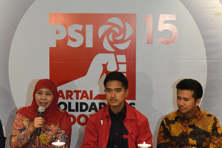 Indonesian Solidarity Party (PSI) chair Kaesang Pangarep accompanies former East Java governor Khofifah Indar Parawansa (left) and her deputy Emil Dardak (right) during a press briefing at the party's headquarters in Jakarta on June 4, 2024. During the meeting, PSI declares its support for the Khofifah-Emil pair for the 2024 East Java gubernatorial election.