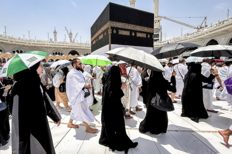 Muslim worshippers walk around the Kaaba, Islam's holiest shrine, at the Grand Mosque in Saudi Arabia's holy city of Mecca on June 13, 2024, ahead of the annual Haj pilgrimage. 