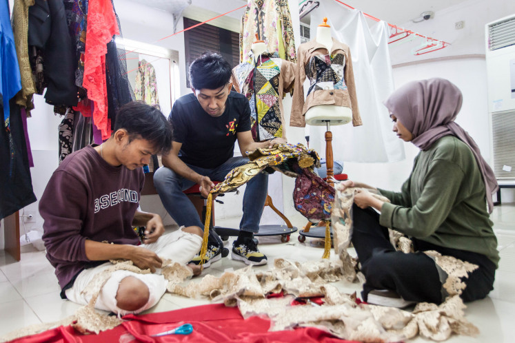 Creative collaboration: Teater Keliling collaborates with local fashion designers for their costumes. Since 2019, Theo Antoinette Rintoko (center), a designer from Salatiga Carnival Center, has been contributing to Teater Keliling’s wardrobe. Theo frequently integrates ethnic elements, such as batik and weaving, into the costume designs. (Courtesy of Okky Ardya)