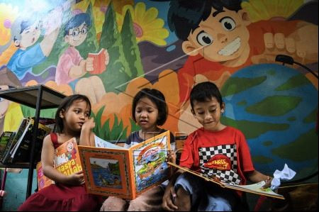 Feeding minds: Children read books at Warna-Warni Reading Park in Tambora, West Jakarta, on May 21, 2024. The government has listed 177 literary works to be utilized as reference materials for teachers nationwide to promote reading habits.