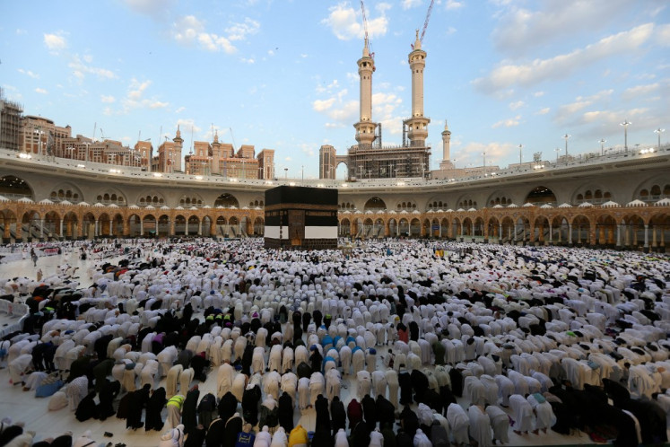 Muslims perform the Eid al-Adha morning prayer around the Kaaba, Islam's holiest shrine, at the Grand Mosque in Saudi Arabia's holy city of Mecca, on the first day of the holiday marking the end of the hajj pilgrimage, on June 16, 2024. 