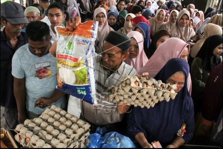 Food for all: Residents of Padang Sakti village in Lhokseumawe city, Aceh, line up for cheap staple food items provided by the local government through a market operation on June 3, 2024. 
