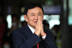 Former Thai prime minister Thaksin Shinawatra greets his supporters on August 22, 2023, after landing at Bangkok's Don Mueang International Airport. Thai prosecutors formally indicted Thaksin on Tuesday under the kingdom's strict lèse-majesté law over comments he made nearly a decade ago.
