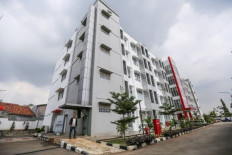Affordable abode: A man walks past the Sentra Mulya Jaya low-cost apartment building in Cipayung, East Jakarta, on Jan. 26, 2024. Built as a joint project managed by the Social Affairs Ministry and the Public Housing and Settlements Ministry, the apartment is available for low-income families to rent at Rp 100,000 (US$6) per month.