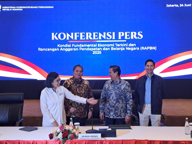 Finance Minister Sri Mulyani (left) , Coordinating Economic Minister Airlangga Hartarto (second left), Thomas Djiwandono (second right) and Budi Djiwandono (right) pose for a photo before a press briefing on the state budget in the Tax Directorate General Jakarta office building on June 24, 2024.