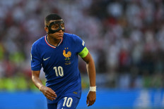 France's forward #10 Kylian Mbappe, wearing a protective mask, looks on during the UEFA Euro 2024 Group D football match between France and Poland at the BVB Stadion in Dortmund on June 25, 2024. 