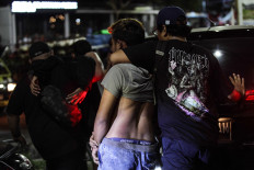 Plain-clothed police officers arrest several individuals suspected of inciting a clash between supporters of the Persib Bandung and Madura United soccer teams on May 31, 2024, in the Kedung Cowek area of Surabaya, East Java, following a match between both teams at Bangkalan Stadium in Bangkalan, East Java.