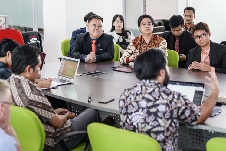 Move Forward Party Member of Parliament Parit Wacharasundhu (top, center) and his lawmaker colleagues from Thailand look on during a discussion with Editor-in-Chief Taufiq Rahman (bottom left) during a media visit to The Jakarta Post office in Jakarta, on June 27, 2024.