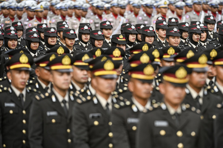 Police officers march on July 1, 2024, during a ceremony to commemorate the 78th anniversary of the National Police at the National Monument (Monas) Square in Jakarta.
