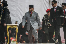 Minister of Defence and president-elect Prabowo Subianto (center) arrives at a ceremony commemorating the National Police Day in Jakarta on July 1, 2024. President-elect Prabowo Subianto has undergone leg surgery but is continuing to work as he recovers, a spokesman said on July 2.