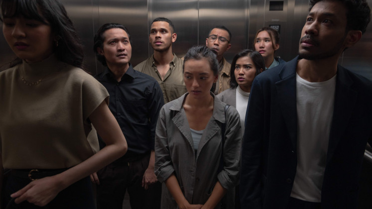 Asmara Abigail’s character (center) is surrounded by other jobseekers for an unknown job in "Joko Anwar’s Nightmares and Daydreams”. 